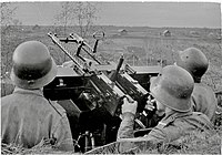 Finnish AA-MG crew in 1942. The soldier in the middle has a German M1916 and other two have Hungarian M38 helmets