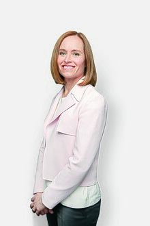 A photograph of Dr. Jeannie Callum with hands clasped, facing the camera