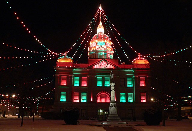 Building with strings of colored lights running from top of cupola to sides of square