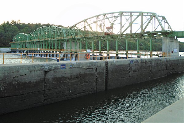 Lock E11 includes a truss structure which spans the river and which has multiple steel gates which can be opened and closed by the use of electric win