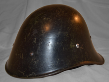 Dutch M34 Helmet, note the removal of the front badge and coat of black paint instead of green. M34D HELMET.png