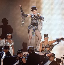 Madonna performing a jazz-themed version of "Music" during the Rebel Heart Tour (2015-2016) Madonna - Rebel Heart Tour 2015 - Washington DC (22794323553) (cropped).jpg