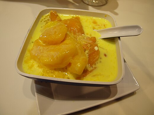 A bowl of mango pomelo sago in a dessert store