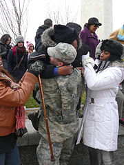 Military police officer in uniform assists lady climbing down from Washington Monument 2 Inauguration 2013.jpg