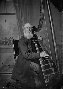 Mr. Roberts of Newtown, Powys playing a triple harp, c. 1875 Mr Roberts, Newtown Harpist NLW3361216 (cropped).jpg