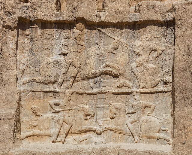 Panels at Naqsh-e Rustam, symbolizing the supposed victories of Bahram II over Carus (top) and Hormizd I Kushanshah (bottom).