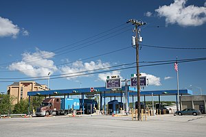 Smaller toll plaza, with semi-trailer truck at a booth