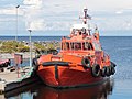 An orange-colored pilot boat at berth in the Marjaniemí harbour in the Hailuoto Island, Finland