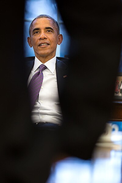 File:President Barack Obama is framed by the arm of Cody Keenan, Director of Speechwriting, during State of the Union prep in the Oval Office.jpg