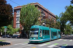 One of the five streetcars that opened the line in 2001, seen westbound on Northwest Northrup Street in 2019 Ptld Streetcar NS Line - Skoda car 003 at NW Northrup & 20th (2019).jpg