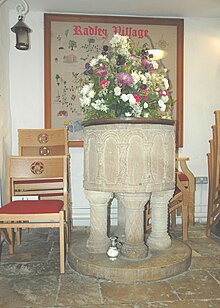 St James the Great parish church: Norman font carved with blind arcading and resting on four colonettes