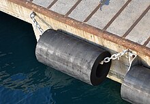 A cylindrical fender in a harbour in Italy Rubber Fender in port Vado Ligure.jpg