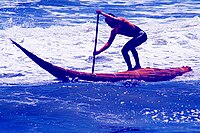 Surfing in a caballito de totora in Huanchaco