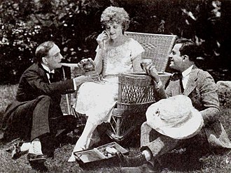 Ramsey Wallace, Miss DuPont (doing her make-up), and Jack Perrin on set in The Rage of Paris (1921) The Rage of Paris (1921) - 1.jpg