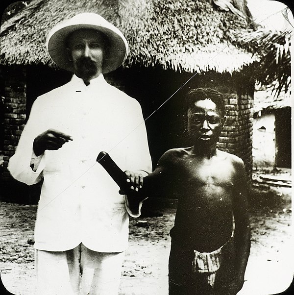 A missionary posing with a victim of the Congo atrocities