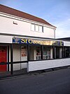 White fronted shop with sign saying St Georges News