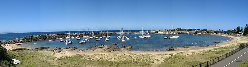 Overlooking Wollongong Harbour towards Flagstaff Point. Wollongong Breakwater Lighthouse is in the centre, while Wollongong Head Lighthouse is visible to the right.