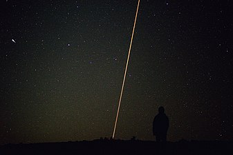 A meteor, a satellite and an aeroplane over the Paranal Observatory, Chile, with a stargazer in the foreground, by Yourong Wang