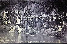 A scene from the 1904-1905 Welsh revival. Dan Davies of Hermon Chapel conducting a baptism in the River Gwaun in 1905. Baptism in the River Gwuan Fishguard Rev Dan Davies circa 1904-05.jpg