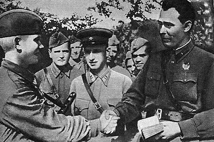 Brigade commissar Brezhnev (right) presents a Communist Party membership card to a soldier on the Eastern Front in 1943.