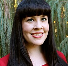 Caitlin Doughty in red evergreen background.jpg