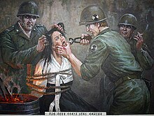 Paintings on the walls of the Sinchon Museum of American War Atrocities depict alleged atrocities carried out by American soldiers during the Korean War. DPRK Museum painting 1.jpg