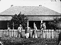 Four people outside the Brighton boarding house in Cleveland, ca. 1871 (5013789868).jpg