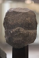 Fragment of the statue of a devotee, with inscription in the name of Naram-Sin: "To the god Erra, for the life of Naram-Sin, the powerful, his companion, the king of the four regions, Shu'astakkal, the scribe, the majordomo, has dedicated his statue".[129]