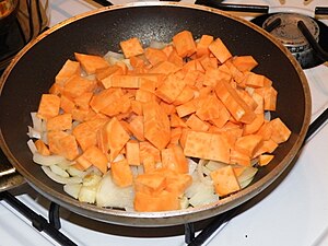 frying oinions and sweet potato for a cream-sauce