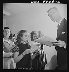 Girl announcing a radio broadcast to Latin America in Spanish