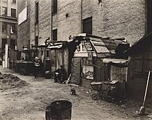 Huts and unemployed men in New York City, 1935. Huts and unemployed, West Houston and Mercer St., Manhattan (NYPL b13668355-482853).jpg