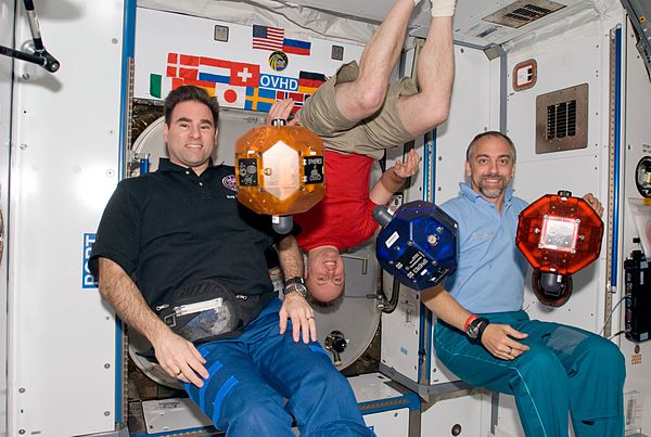 Richard Garriott (far right) aboard the ISS on October 23, 2008, with the MIT SPHERES Satellites.