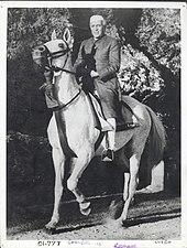 Jawaharlal Nehru in an achkan or sherwani, a garment which served as a model for the Nehru jacket. Jawaharlal Nehru on horseback in Achkan and chooridar.jpg