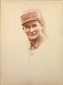 An old, brown picture of a soldier named Paul Pavelka, who is wearing a military suit and cap.