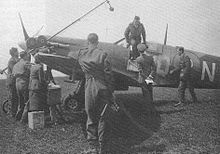 RAF ace Johnnie Johnson climbing out of the cockpit of his Spitfire at Kings Cliffe, 1941