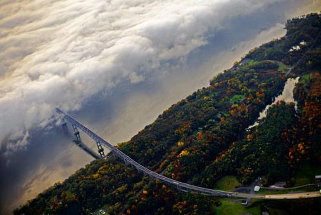 Westward commuters drive into fog which covers the Rhinecliff half of the Kingston–Rhinecliff Bridge on a fall morning