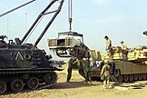 U.S. Marines use an M88A1 to load a Honeywell AGT1500 gas turbine engine back into an M1A1 Abrams at Camp Coyote, Kuwait, February 2003.