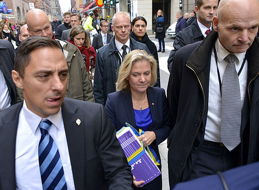 Säpo close protection officers surrounding the Minister for Finance Magdalena Andersson in 2014.