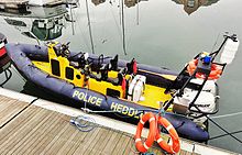 A rigid-hulled inflatable boat (RHIB) used by the UK's North West Police Underwater Search & Marine Unit. It is marked as both POLICE and HEDDLU, as it operates in both England and Wales North West Police Underwater Search & Marine Unit RIB.JPG