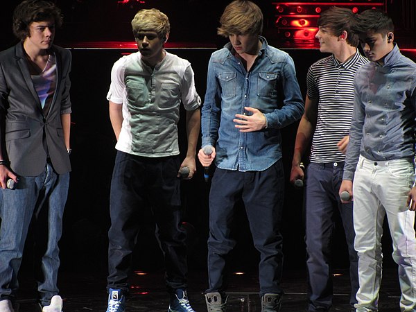 Styles (left) with One Direction on The X Factor Live Tour in 2011