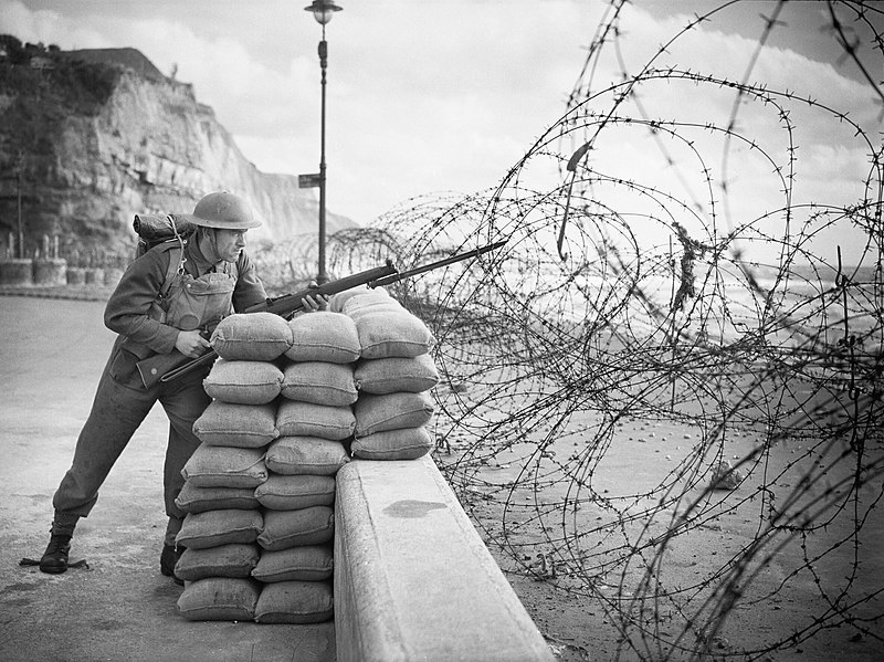 File:Posed portrait of a soldier with rifle and bayonet standing watch behind beach defences 'somewhere in Southern England', 15 October 1940. H4733.jpg