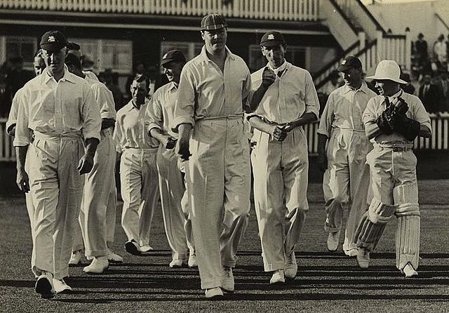 Chapman (centre) leads the England team on to the field during the Brisbane Test.