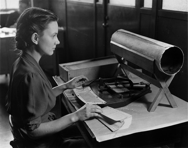 Woman operating an original Hollerith card punch