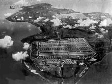 Tinian Island in 1945: the vast North Field airfield is in the foreground with West Field beyond; the rest of the island is filled with barracks, buildings, and hangars Tinian Airfields 1945 Looking North To South.jpg