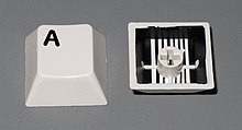 Two-shot injection moulded keycaps from a computer keyboard Two-shot injection molded keycaps.jpg