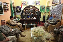 U.S. Army officers with 3rd Battalion, 82nd Field Artillery Regiment conduct a key leader engagement to discuss current events with Iraqi police officials in Samarra, Salah al-Din province, Iraq, Aug 110815-A-YV529-009.jpg