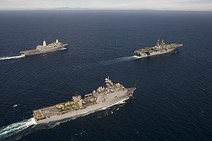 Three US amphibious warfare ships - a landing helicopter dock leading a landing platform dock (rear) and a landing ship dock (fore) US Navy 111010-N-KD852-492 The amphibious dock landing ship USS Pearl Harbor (LSD 52), front, the amphibious assault ship Makin Island USS Makin Is.jpg