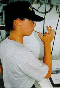 U.S. Coast Guard Boatswain's Mate 3rd Class Jessica Walsh practices her technique with the boatswain's pipe. Uscg-bm3-piping.jpg