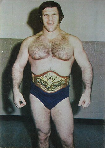 Two-time champion Bruno Sammartino. His first reign is the longest at over seven years (2,803 days) and he has the longest combined reign (4,040 days); he is pictured here in his second reign (1973–1982 belt design) when the title was known as the WWWF Heavyweight Championship