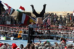 Jeff Hardy performing his Swanton Bomb (high-angle senton bomb) finisher to Carlito WWE Flies Into Iraq DVIDS68607.jpg